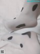 A pair of white tights with black spots on them.